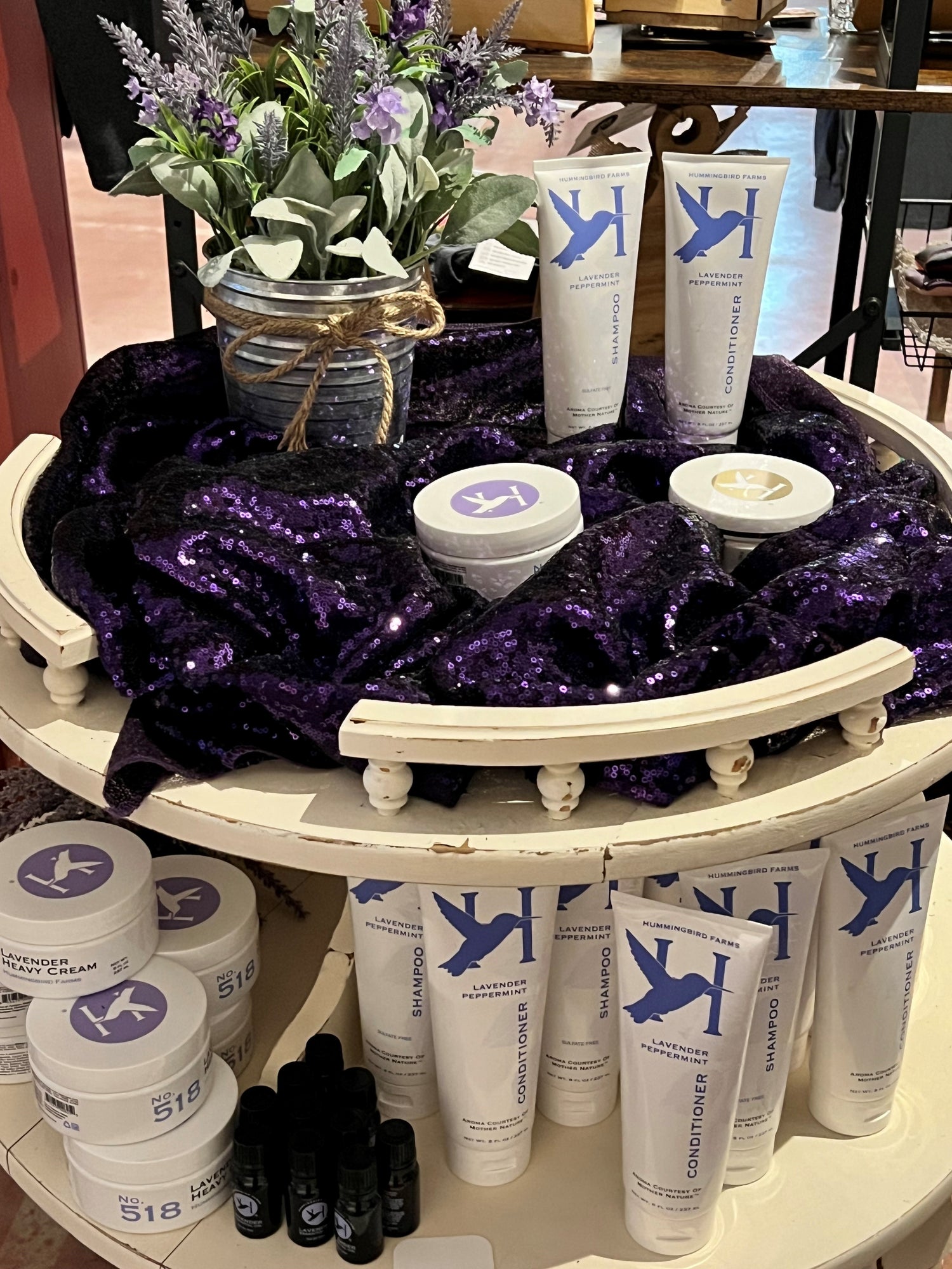 Shoppe 826 Body Care and Lotion on a table with Lavender flowers