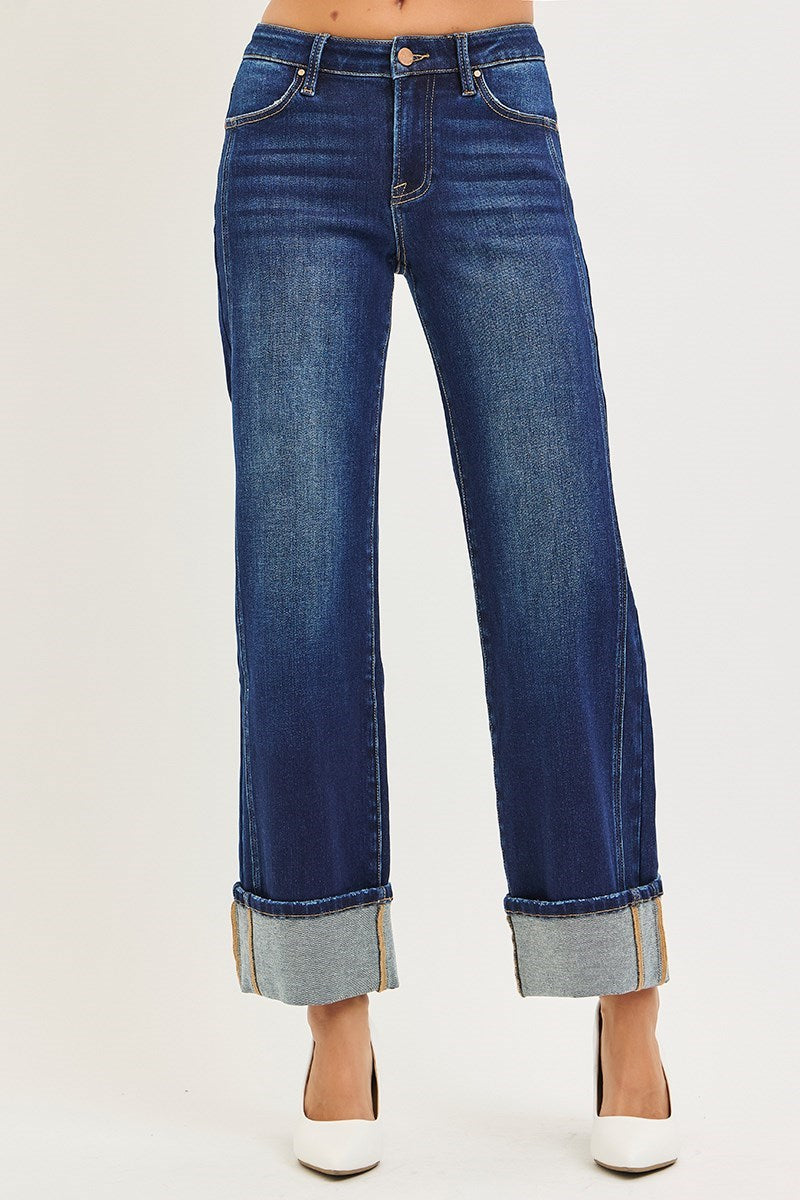 Blue jeans with cuffed hems on a white background