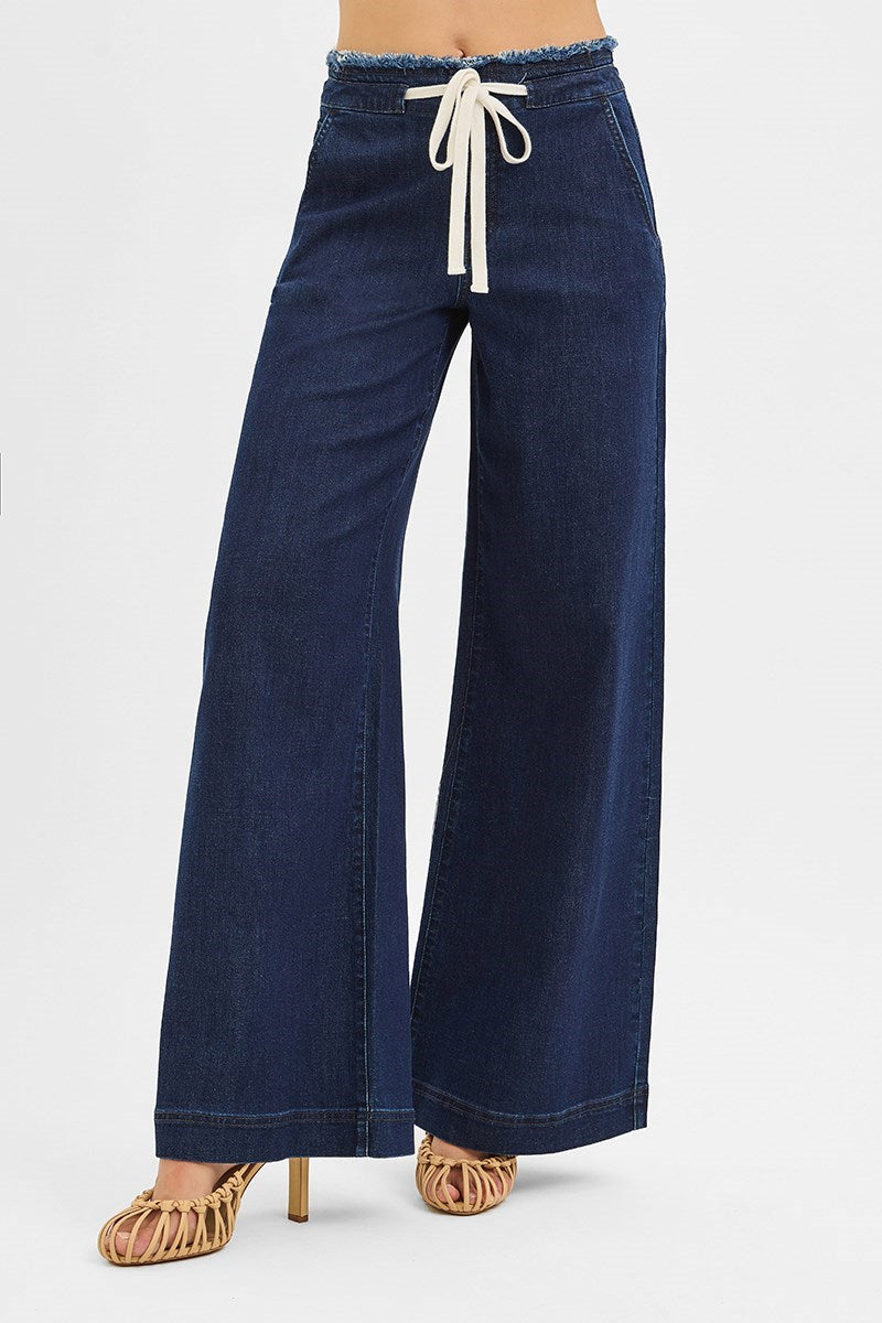 Navy blue wide-leg pants with a white drawstring on a light gray background