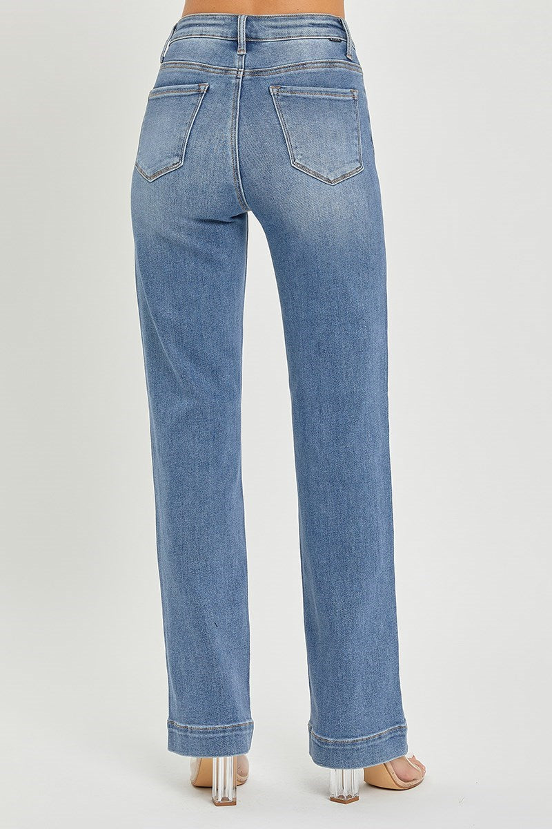 Blue jeans worn by a person on a light gray background