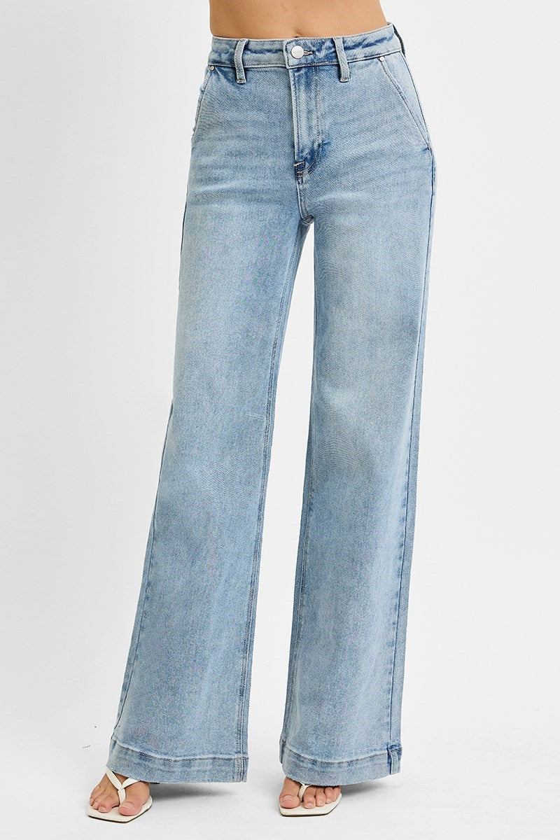 A pair of high-rise, wide leg slanted pocket jeans in a light blue wash.